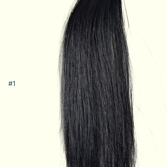 A close-up of a straight, Jet Black hair extension section on a plain off-white background, with the text '#1' printed in blue on the left side.