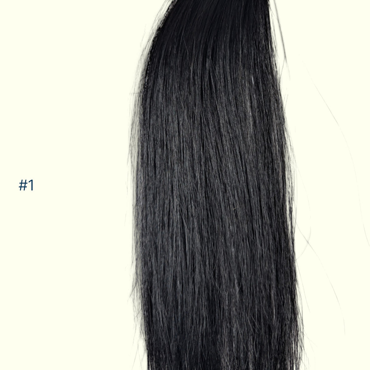 A close-up of a straight, Jet Black hair extension section on a plain off-white background, with the text '#1' printed in blue on the left side.